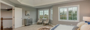 Bedroom with tan carpeting