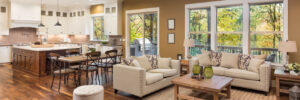 Hardwood flooring spanning from kitchen to living room in open concept home